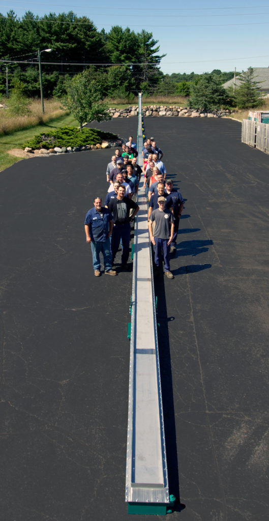 MPI Employees with 224 foot beltless magnetic conveyor, conveyor magnets, conveyor magnet