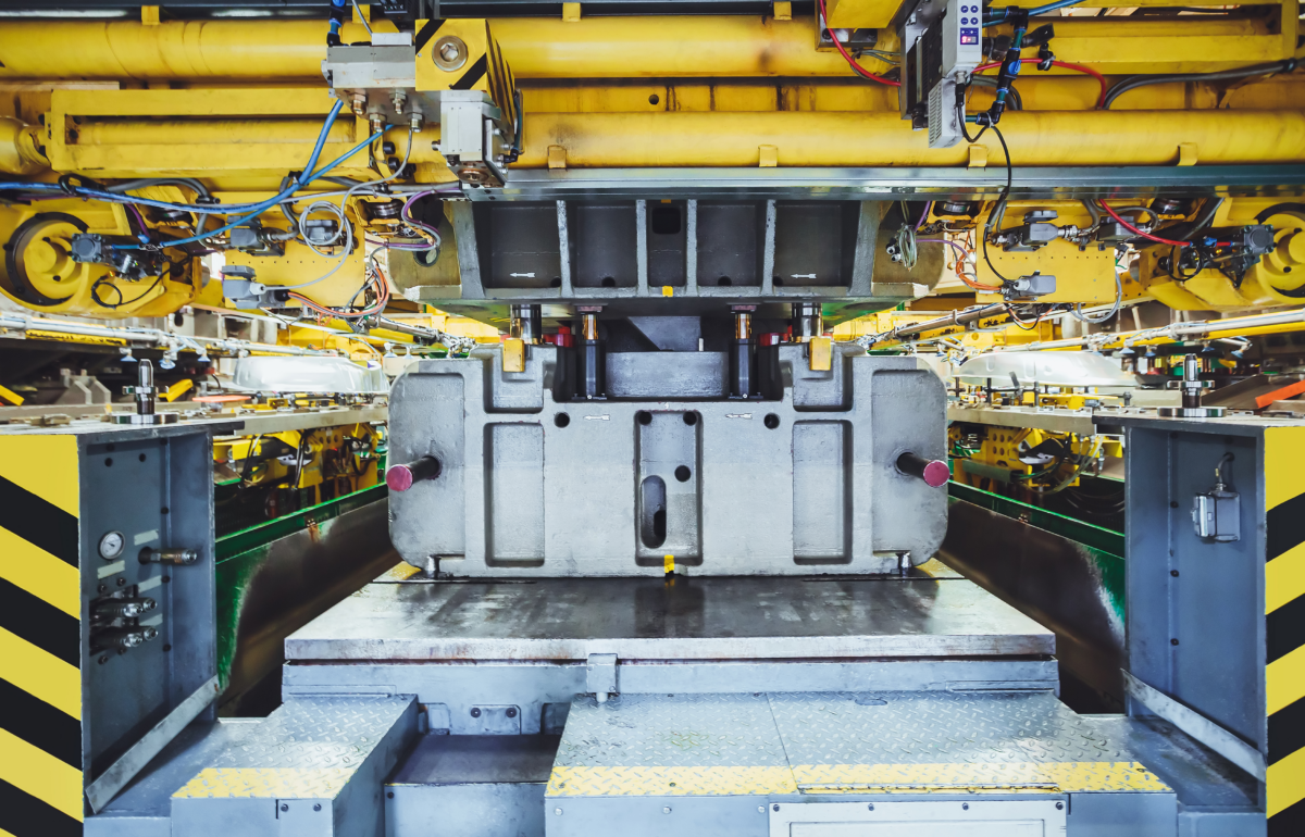 Metal stamping press in operation in factory setting