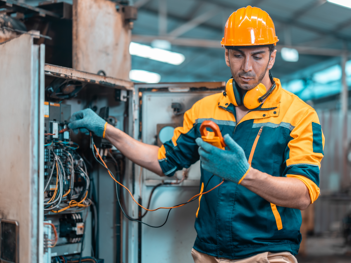 Repair technician diagnosing industrial equipment